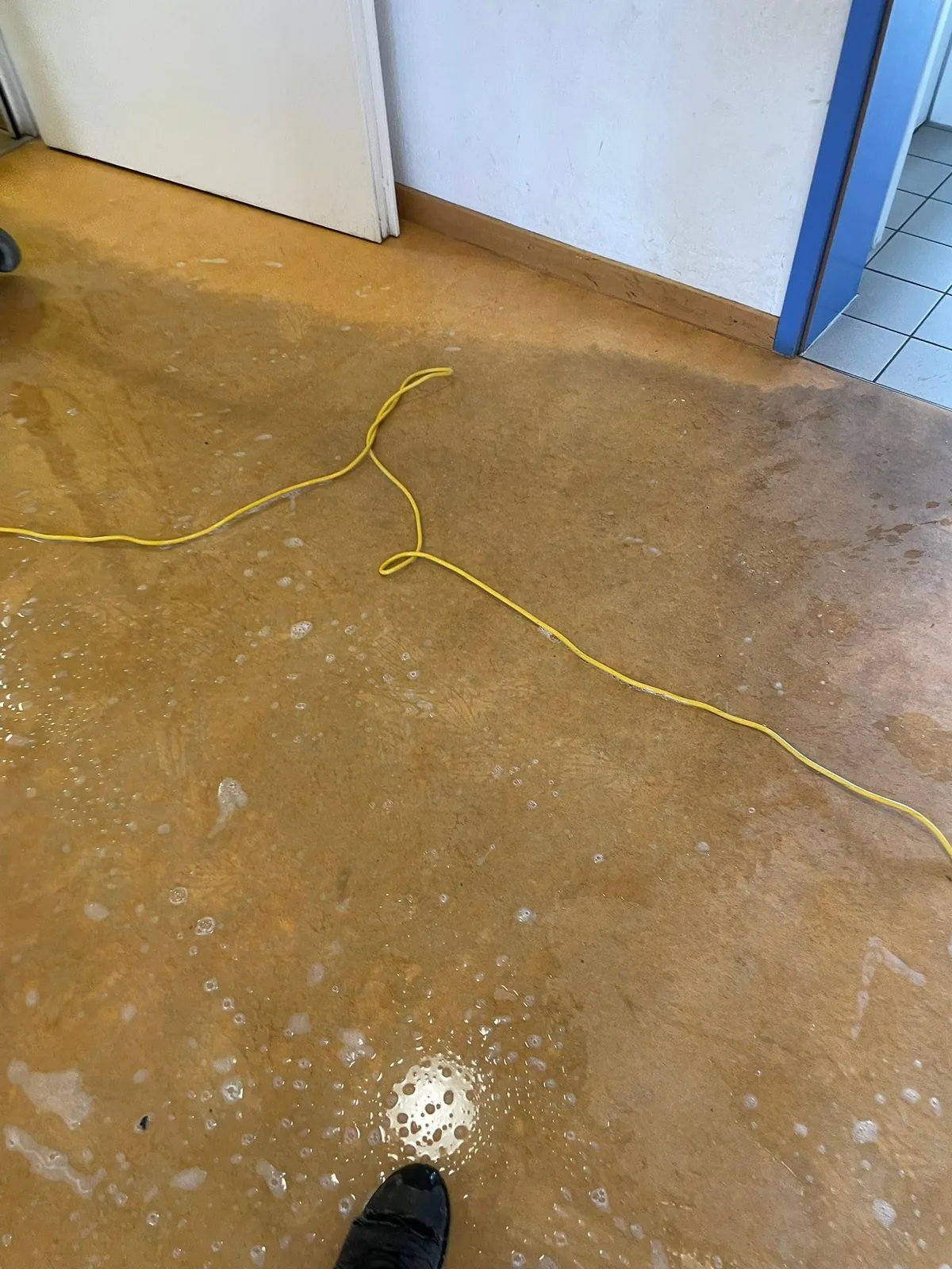 Linoleumboden einer Schule mit fleckiger, wolkiger Oberfläche vor der Grundreinigung